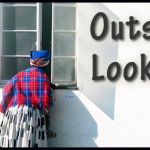 Woman standing outside looking into window